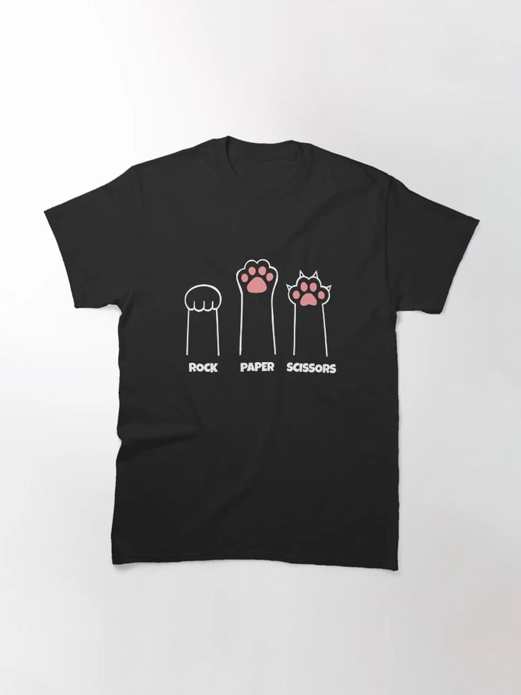 Black tee featuring three illustrated cat paws labeled “Rock,” “Paper,” and “Scissors” in white and pink