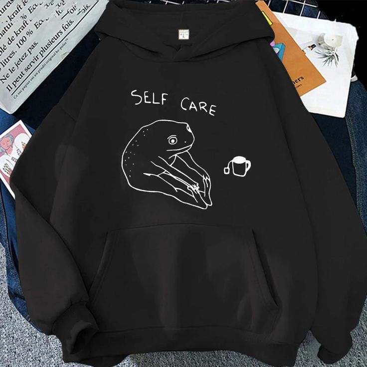 White hoodie with a minimalist “Self Care” frog graphic and tea cup, cozy unisex style
