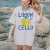 White oversized t-shirt with a lemon graphic and text “Limoncello – la dolce vita” in blue and yellow
