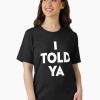 Women Black t-shirt with bold white text saying “I TOLD YA” in stacked, capitalized font.