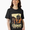 Women Black t-shirt featuring sunset silhouette of The Goonies crew and pirate ship with “The Goonies Never Say Die” text
