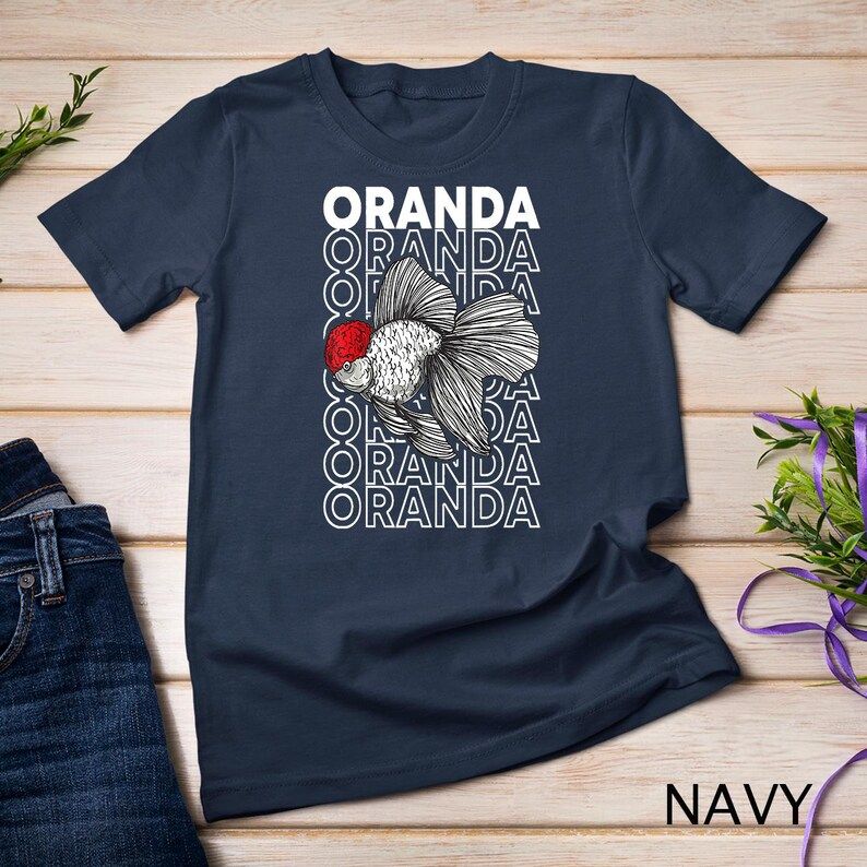 Navy t-shirt featuring a detailed Oranda goldfish with a red head and stacked “ORANDA” text in white behind the fish.