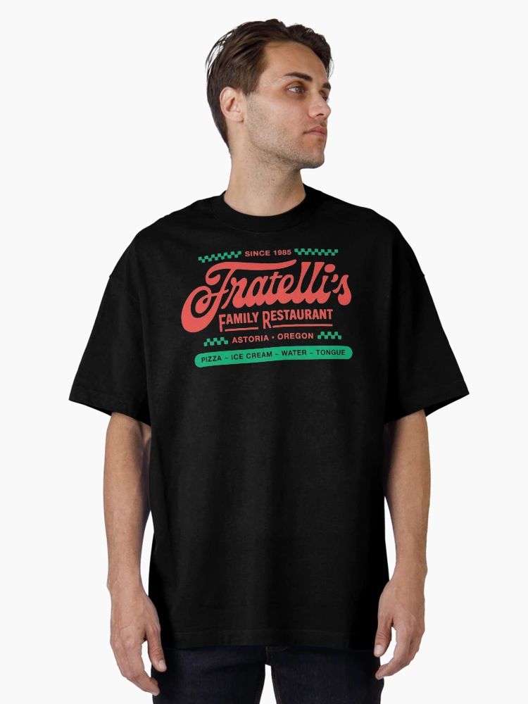 Men Black t-shirt with red and green retro logo reading “Fratelli’s Family Restaurant – Astoria Oregon” and playful food list.