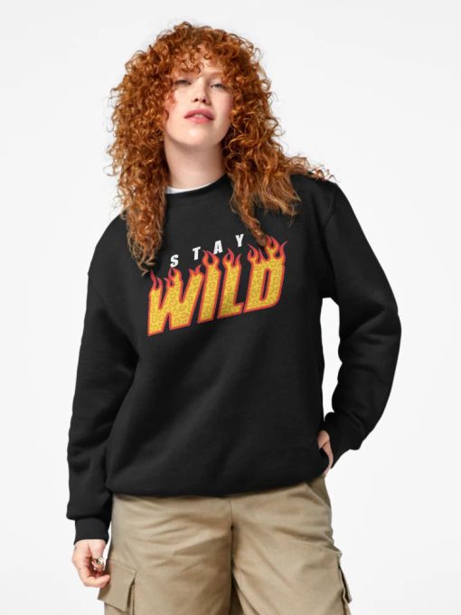 Women Black Sweatshirt with “Stay Wild” flame-text design in yellow and red, worn by a smiling male model