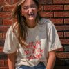 Beige t-shirt featuring a group of hand-drawn red goldfish in a minimalist, sketch-style design