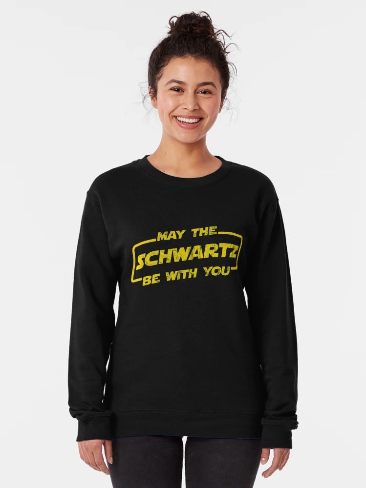 Black sweatshirt with distressed yellow “May The Schwartz Be With You” text in sci-fi parody font.