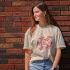 Beige t-shirt featuring a group of hand-drawn red goldfish in a minimalist, sketch-style design