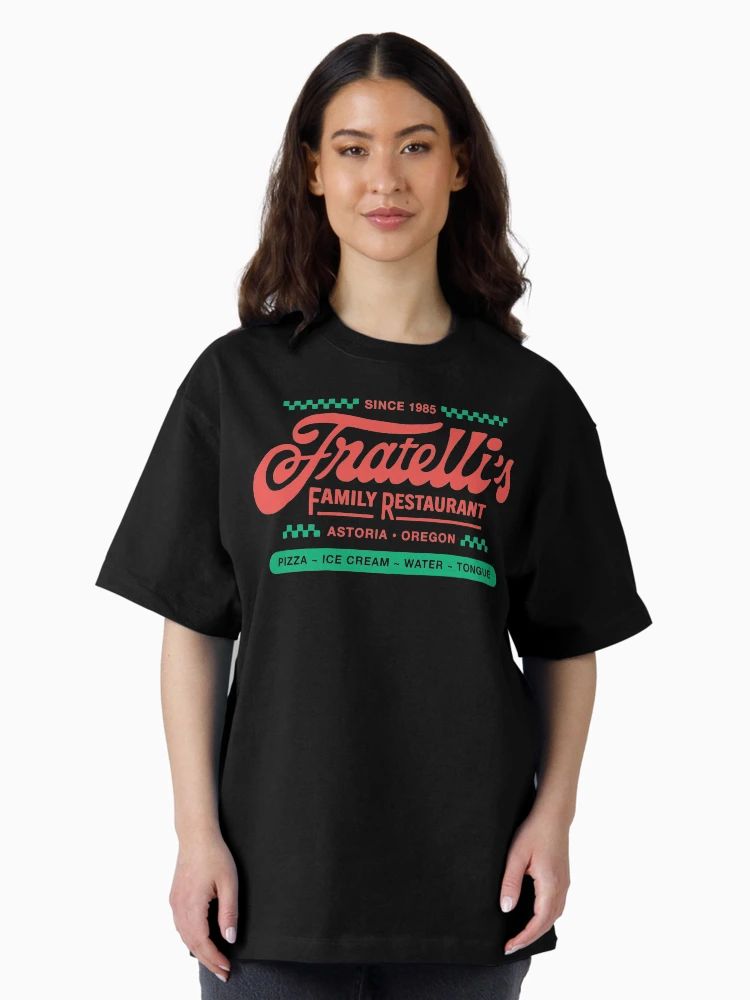 Black t-shirt with red and green retro logo reading “Fratelli’s Family Restaurant – Astoria Oregon” and playful food list