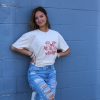 Beige t-shirt featuring a group of hand-drawn red goldfish in a minimalist, sketch-style design