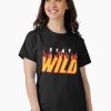 Women Black T-Shirt with “Stay Wild” flame-text design in yellow and red, worn by a smiling male model