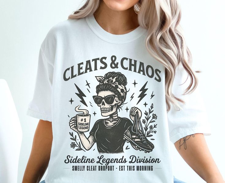 t-shirt with “Cleats & Chaos” skeleton mom graphic holding coffee mug and cleats, with lightning bolt accents.