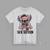 Six Seven Christmas Stitch Alien T-Shirt Cartoon pink alien creature wearing Santa hat and scarf making hand sign with text Six Seven Christmas graphic T-Shirt