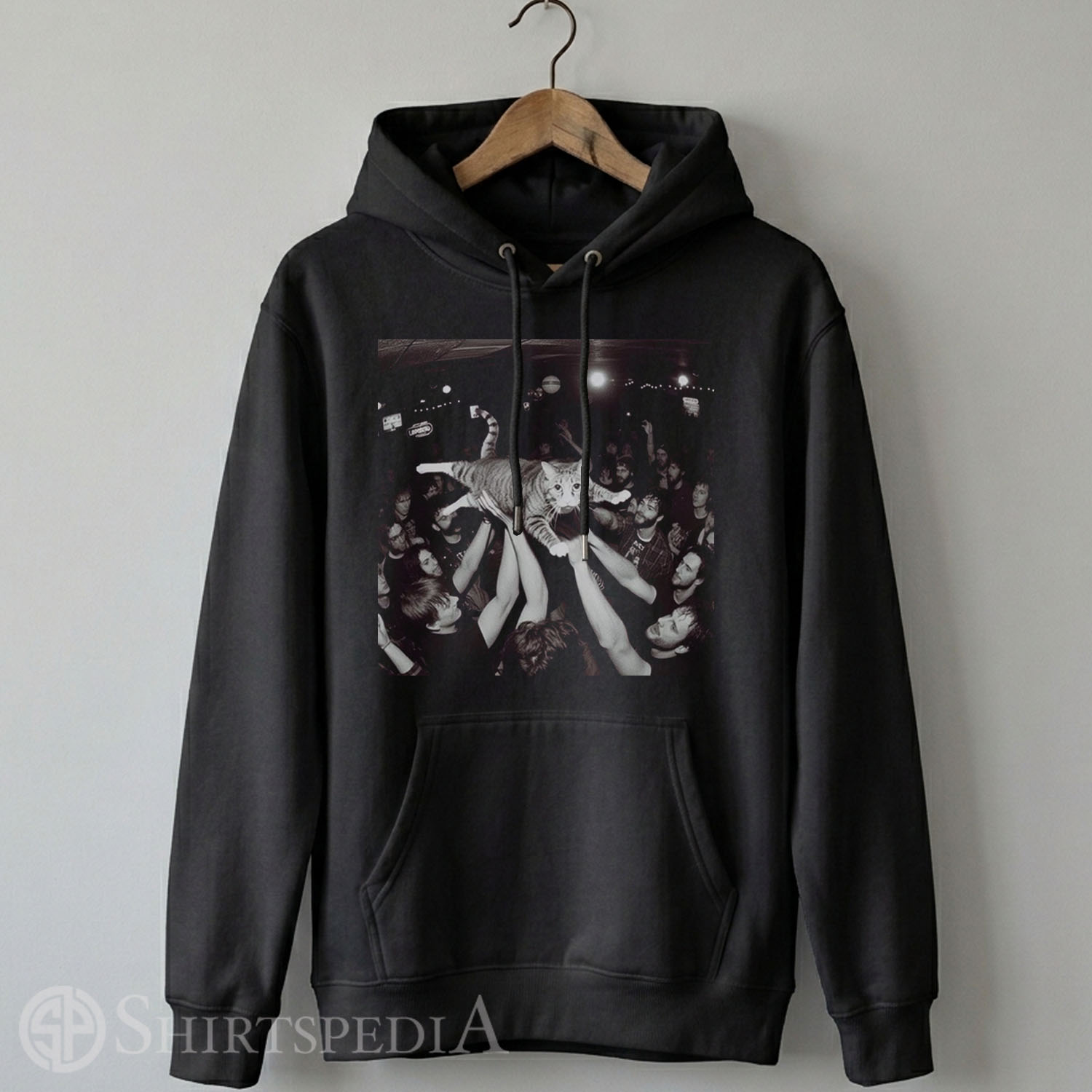 Heavyweight black streetwear hoodie with an adjustable drawstring hood, displaying a large central graphic of a cat crowd surfing at a rock concert.