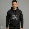 Mens Heavyweight black streetwear hoodie with an adjustable drawstring hood, displaying a large central graphic of a cat crowd surfing at a rock concert.