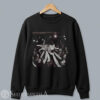 Unisex black crewneck pullover sweatshirt featuring a large central graphic of a crowd-surfing cat at a live rock concert.
