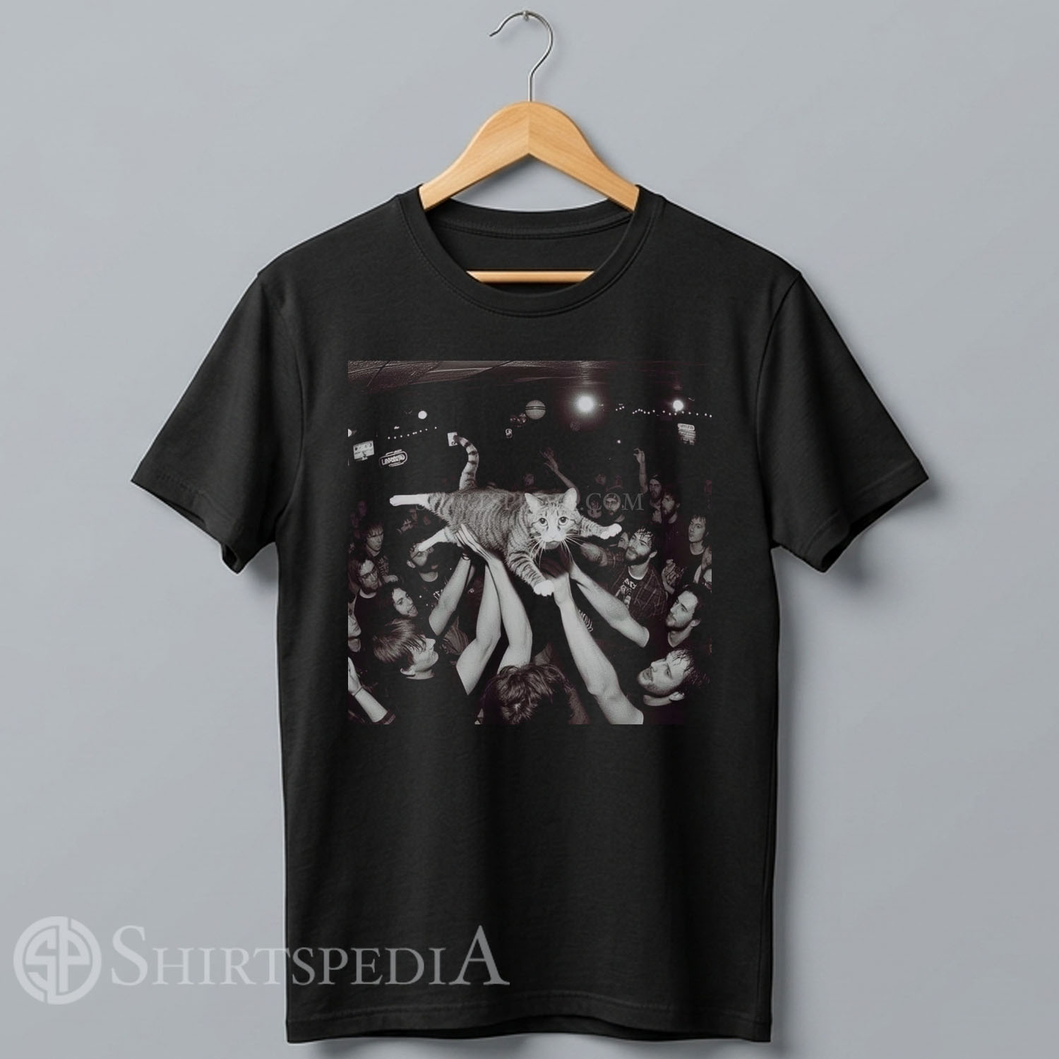 black streetwear t-shirt featuring a funny cartoon graphic of an ecstatic cat crowd surfing over a hands-raised concert audience.